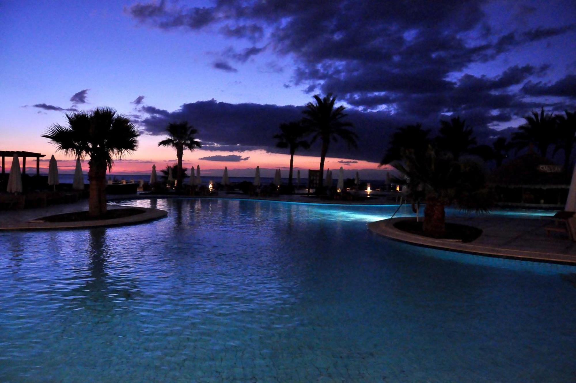 Safir Sharm Waterfalls Resort Exterior photo Sunset at the pool